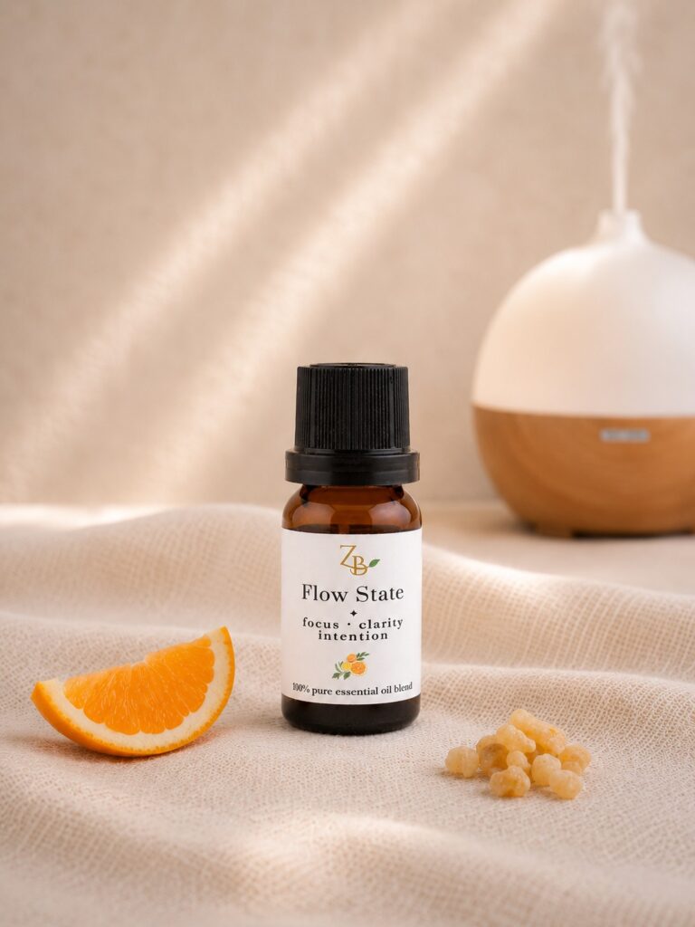 10ml amber diffuser bottle with orange slice, frankincense and a diffuser in the background