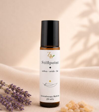Stillpoint aromatherapy roll-on with lavender and frankincense beside dried lavender and frankincense resin