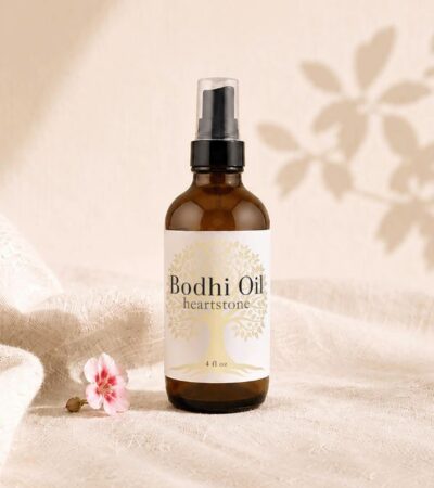 amber body oil bottle with small geranium bud