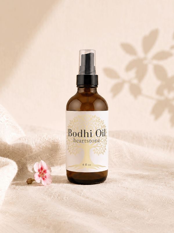 amber body oil bottle with small geranium bud