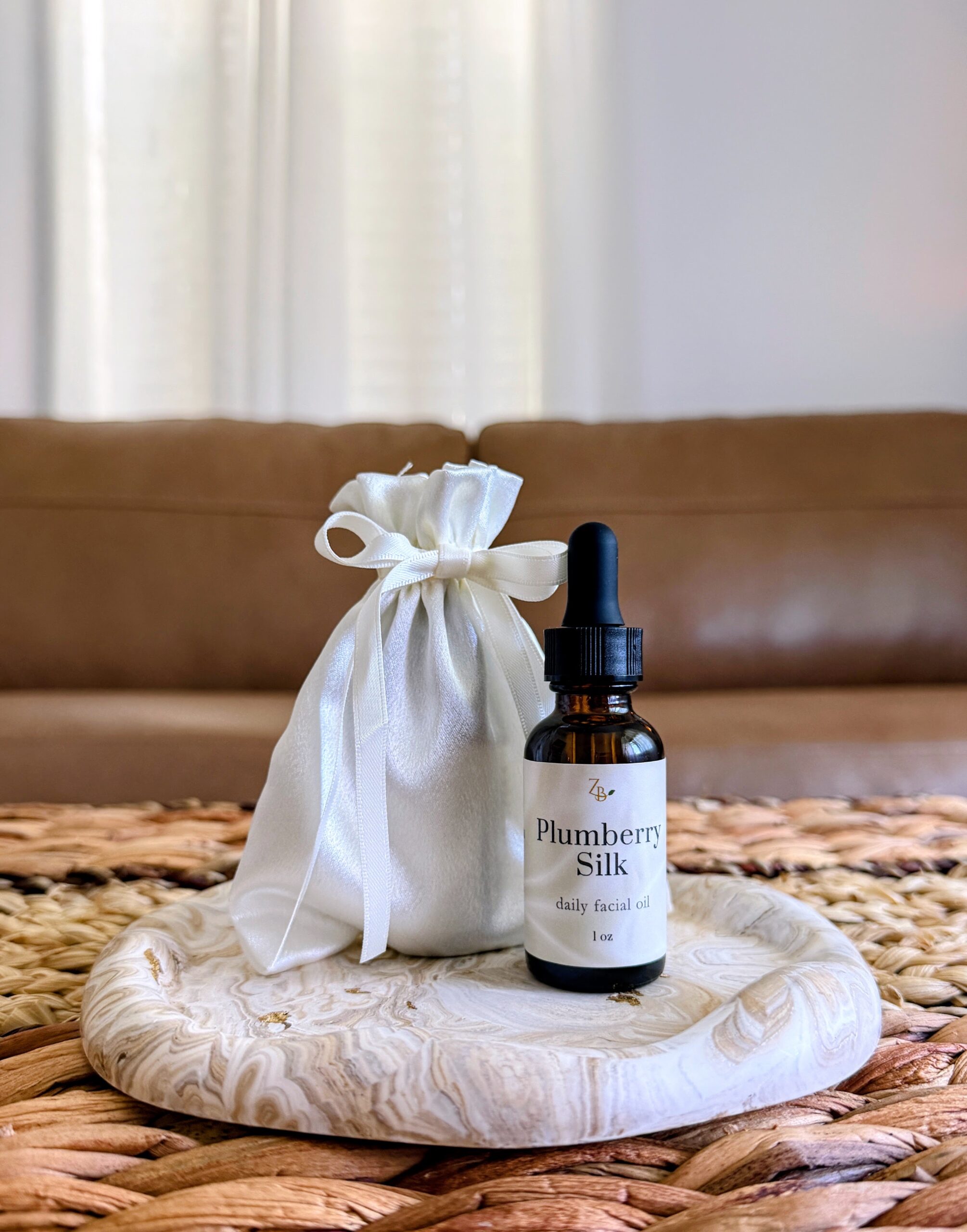 Plumberry silk facial oil in a silky pouch