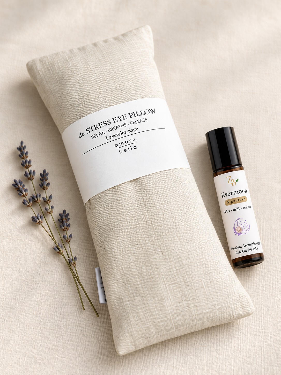 Lavender-Sage linen eye pillow with Evermoon aromatherapy roll-on and fresh lavender sprigs